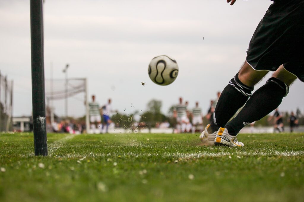 person kicking football