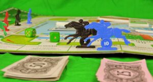 horse racing figurine on board with cash